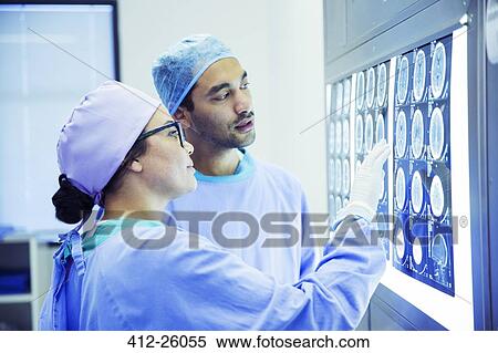 Surgeons reviewing and discussing MRI scans View Large Photo Image Stock Photography - Surgeons reviewing and discussing MRI scans. Fotosearch