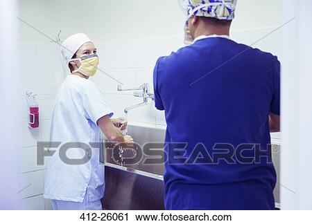 Surgeons washing hands in hospital View Large Photo Image Stock Image - Surgeons washing hands in hospital. Fotosearch