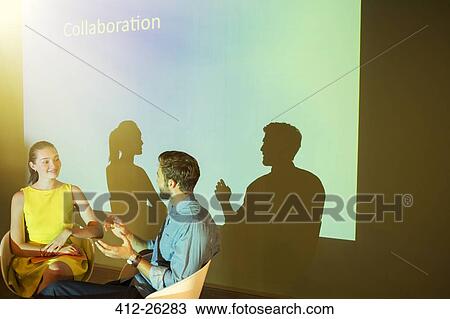 Stock Image - Business people discussing Collaboration in audio visual presentation. Fotosearch