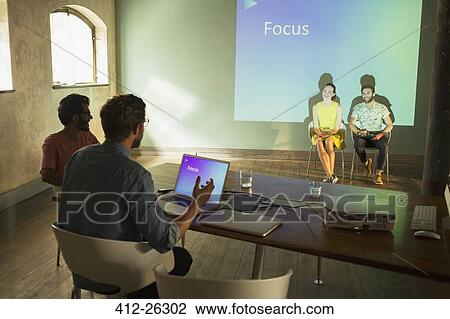 Stock Image - Business people preparing audio visual presentation on Focus. Fotosearch