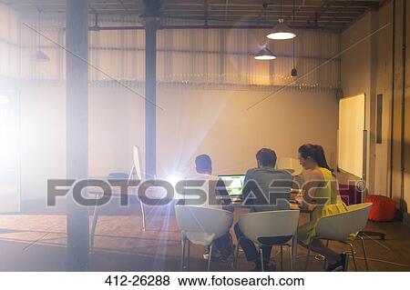 Business people preparing audio visual presentation at laptop in conference room View Large Photo Image Stock Photo - Business people preparing audio visual presentation at laptop in conference room. Fotosearch