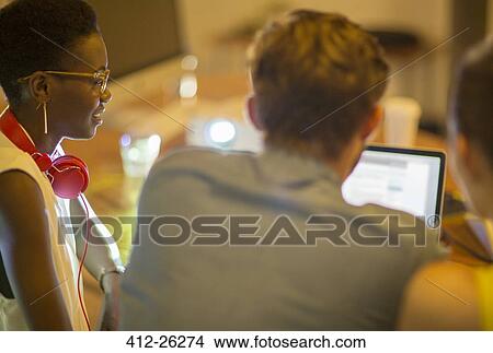 Picture - Business people using laptop. Fotosearch