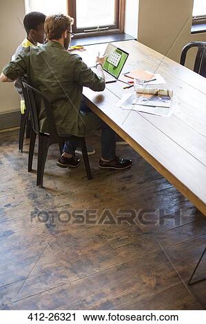 Business people working at laptop in office View Large Photo Image Stock Image - Business people working at laptop in office. Fotosearch