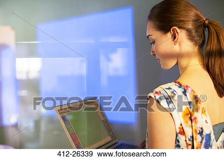 Businesswoman with laptop preparing audio visual presentation View Large Photo Image Stock Photo - Businesswoman with laptop preparing audio visual presentation. Fotosearch