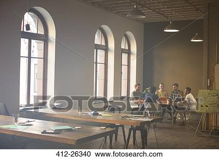 Casual business people meeting at table in office View Large Photo Image Stock Image - Casual business people meeting at table in office. Fotosearch