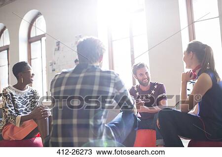 Casual business people meeting in circle in sunny office View Large Photo Image Stock Image - Casual business people meeting in circle in sunny office. Fotosearch