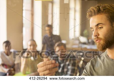 Casual businessman explaining diagram on glass in meeting View Large Photo Image Picture - Casual businessman explaining diagram on glass in meeting. Fotosearch