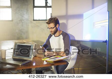 Casual businessman preparing audio visual presentation in office View Large Photo Image Stock Photo - Casual businessman preparing audio visual presentation in office. Fotosearch