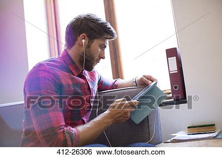 Casual businessman with headphones and digital tablet View Large Photo Image Stock Photograph - Casual businessman with headphones and digital tablet. Fotosearch