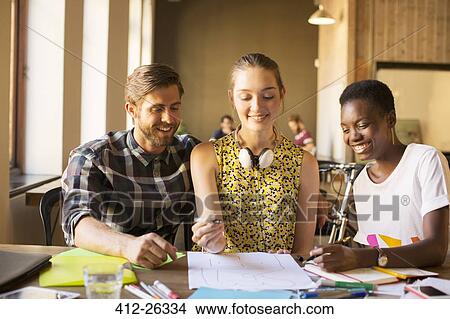 Creative business people brainstorming drawing diagram in office View Large Photo Image Picture - Creative business people brainstorming drawing diagram in office. Fotosearch