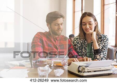 Stock Photo - Creative business people working at typewriter. Fotosearch