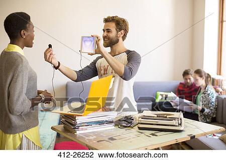 Creative businessman holding digital tablet and headphone View Large Photo Image Stock Image - Creative businessman holding digital tablet and headphone. Fotosearch