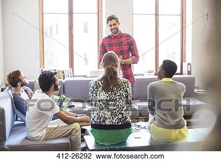 Stock Image - Creative businessman leading meeting in office. Fotosearch