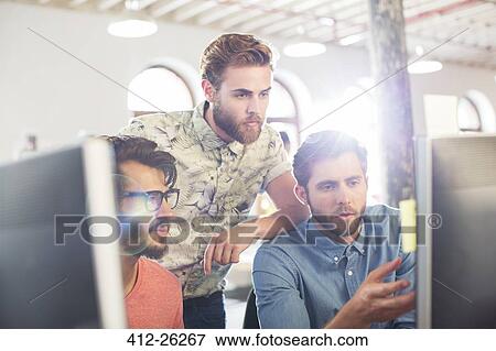 Stock Photo - Focused casual businessmen working at computers. Fotosearch