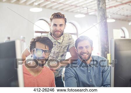 Stock Photograph - Portrait casual businessmen smiling in office. Fotosearch