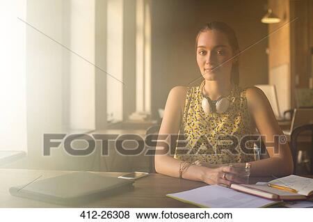 Portrait casual businesswoman with headphones working in office View Large Photo Image Stock Photo - Portrait casual businesswoman with headphones working in office. Fotosearch