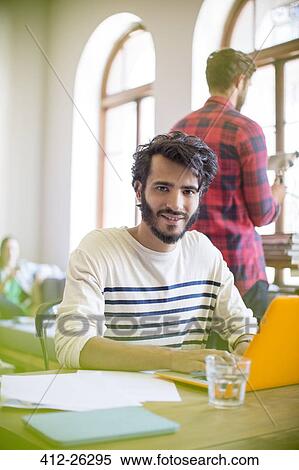 Portrait confident casual businessman using laptop in office View Large Photo Image Stock Photography - Portrait confident casual businessman using laptop in office. Fotosearch