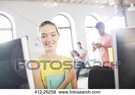 Stock Photo - Portrait smiling businesswoman at computer in office. Fotosearch