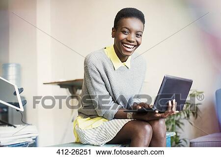 Stock Image - Portrait smiling businesswoman working with digital tablet. Fotosearch