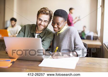 Smiling creative business people using laptop and brainstorming View Large Photo Image Stock Photo - Smiling creative business people using laptop and brainstorming. Fotosearch