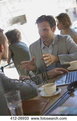 Businessmen talking and gesturing at cafe View Large Photo Image Stock Image - Businessmen talking and gesturing at cafe. Fotosearch