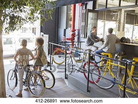 People with bicycles at urban outdoor cafe View Large Photo Image Stock Image - People with bicycles at urban outdoor cafe. Fotosearch