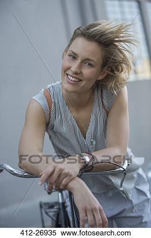 Portrait smiling blonde woman on bicycle View Large Photo Image Stock Photography - Portrait smiling blonde woman on bicycle. Fotosearch