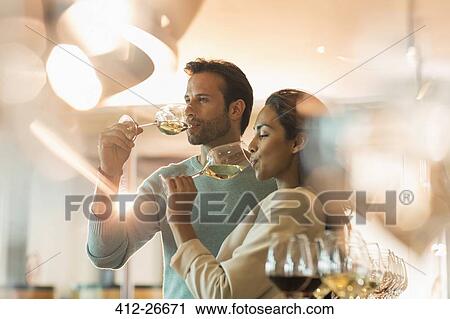 Couple wine tasting white wine in winery tasting room View Large Photo Image Stock Image - Couple wine tasting white wine in winery tasting room. Fotosearch
