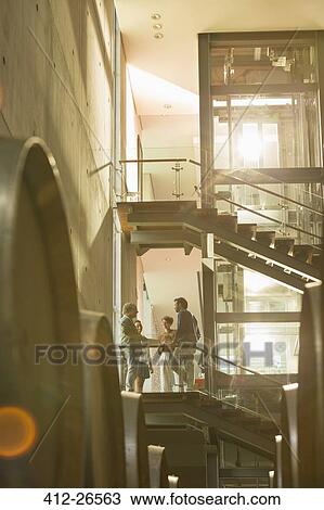 Employees talking on platform in winery View Large Photo Image Stock Image - Employees talking on platform in winery. Fotosearch