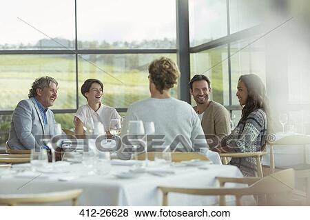 Friends at winery dining room table View Large Photo Image Stock Photo - Friends at winery dining room table. Fotosearch