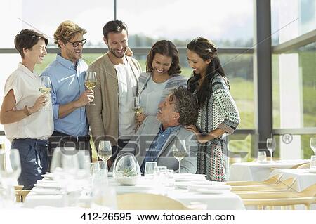 Friends drinking wine in winery dining room View Large Photo Image Stock Photography - Friends drinking wine in winery dining room. Fotosearch