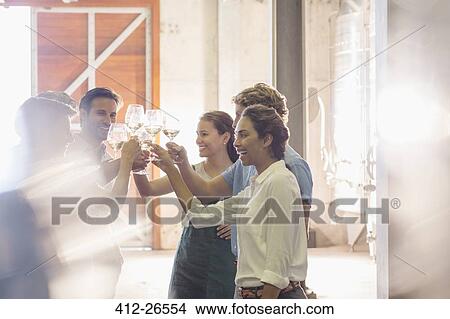 Friends toasting wine glasses at winery View Large Photo Image Picture - Friends toasting wine glasses at winery. Fotosearch
