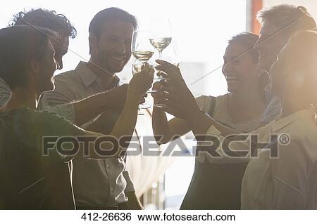 Friends toasting wine glasses View Large Photo Image Stock Photograph - Friends toasting wine glasses. Fotosearch
