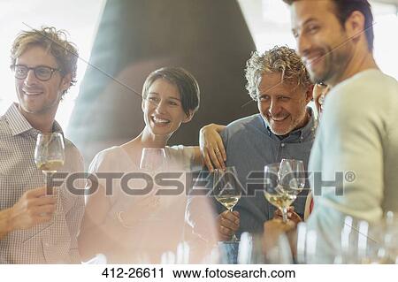 Friends wine tasting in winery tasting room View Large Photo Image Stock Image - Friends wine tasting in winery tasting room. Fotosearch