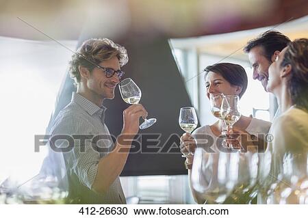 Friends wine tasting in winery tasting room View Large Photo Image Stock Image - Friends wine tasting in winery tasting room. Fotosearch