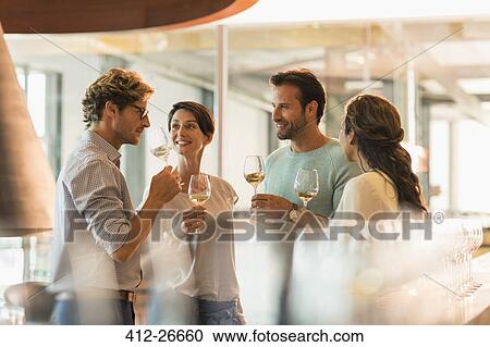 Friends wine tasting white wine in winery tasting room View Large Photo Image Stock Image - Friends wine tasting white wine in winery tasting room. Fotosearch