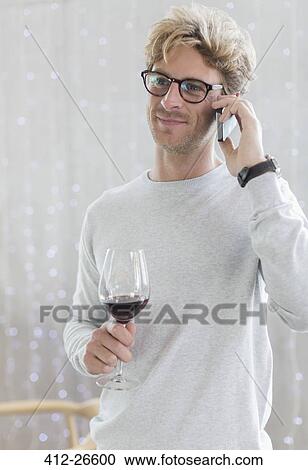 Man drinking red wine and talking on cell phone View Large Photo Image Stock Image - Man drinking red wine and talking on cell phone. Fotosearch