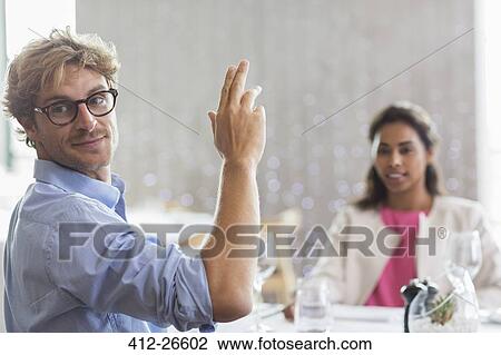 Man gesturing for service at restaurant table View Large Photo Image Stock Image - Man gesturing for service at restaurant table. Fotosearch