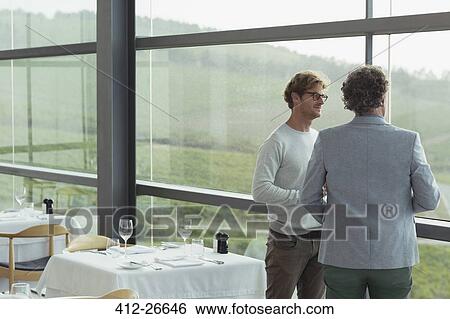 Men talking at winery dining room window View Large Photo Image Stock Photograph - Men talking at winery dining room window. Fotosearch