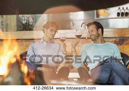 Men wine tasting at fireplace in winery tasting room View Large Photo Image Picture - Men wine tasting at fireplace in winery tasting room. Fotosearch