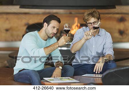 Men wine tasting red wine in winery tasting room View Large Photo Image Stock Image - Men wine tasting red wine in winery tasting room. Fotosearch