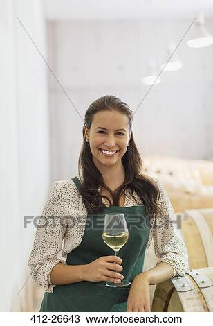 Portrait confident vintner with white wine in cellar View Large Photo Image Stock Image - Portrait confident vintner with white wine in cellar. Fotosearch