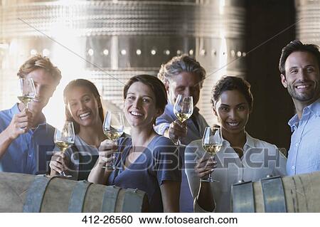 Portrait smiling friends wine tasting in winery cellar View Large Photo Image Stock Image - Portrait smiling friends wine tasting in winery cellar. Fotosearch