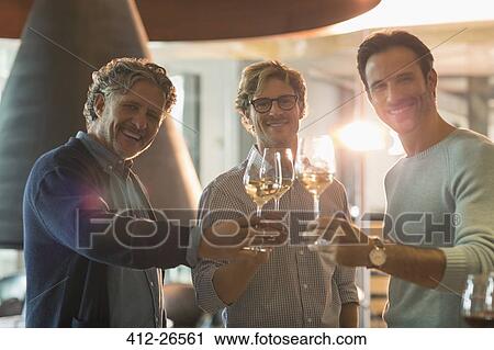 Portrait smiling men drinking white wine at winery View Large Photo Image Stock Image - Portrait smiling men drinking white wine at winery. Fotosearch