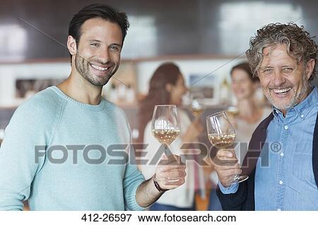 Portrait smiling men wine tasting at winery tasting room View Large Photo Image Stock Photo - Portrait smiling men wine tasting at winery tasting room. Fotosearch