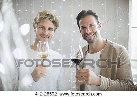 Stock Image - Portrait smiling men wine tasting. Fotosearch