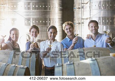 Portrait smiling winery employees barrel tasting in cellar View Large Photo Image Stock Photo - Portrait smiling winery employees barrel tasting in cellar. Fotosearch