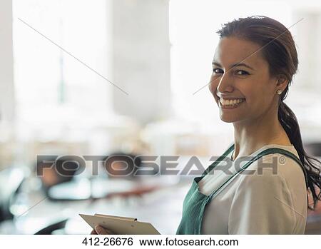 Stock Photograph - Portrait smiling winery tasting room worker. Fotosearch