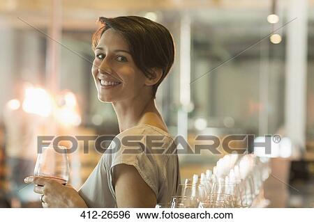 Portrait smiling woman wine tasting at winery tasting room View Large Photo Image Stock Photograph - Portrait smiling woman wine tasting at winery tasting room. Fotosearch