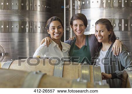 Portrait smiling women in winery cellar View Large Photo Image Stock Photo - Portrait smiling women in winery cellar. Fotosearch